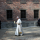 The pontiff walks to the Death Wall, the site where several thousand prisoners were shot dead.